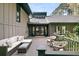 Back patio with wood decking, comfortable wicker furniture, and access to the home's interior at 3610 Legareville Rd, Johns Island, SC 29455