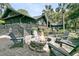 Charming backyard featuring a brick fire pit and cozy seating area at 3610 Legareville Rd, Johns Island, SC 29455