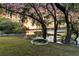 Scenic waterfront backyard featuring a rope swing overlooking the serene water and sunset at 3610 Legareville Rd, Johns Island, SC 29455
