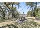 Expansive backyard with a large wooden picnic table and lovely view of the waterfront at 3610 Legareville Rd, Johns Island, SC 29455
