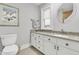 Bright bathroom featuring granite countertop, vanity with traditional hardware, and decorative painting at 3610 Legareville Rd, Johns Island, SC 29455