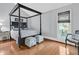 Comfortable bedroom with four poster bed, hardwood floors, and ample natural light at 3610 Legareville Rd, Johns Island, SC 29455