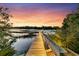 Tranquil shot of the home's private dock at sunset, offering picturesque water views at 3610 Legareville Rd, Johns Island, SC 29455