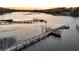 Exterior view of the property's long wooden dock featuring kayak storage and boat lift at 3610 Legareville Rd, Johns Island, SC 29455