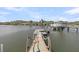 Wooden dock with boat lift offers access to waterfront activities, set against a backdrop of blue sky and calm waters at 3610 Legareville Rd, Johns Island, SC 29455