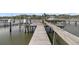 Picturesque view of a private dock equipped with boat lifts and seating areas at 3610 Legareville Rd, Johns Island, SC 29455