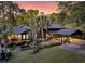 Beautiful home with lush landscaping, a covered carport, and an elegant water fountain at 3610 Legareville Rd, Johns Island, SC 29455