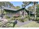 Well-maintained home with a spacious porch and lush landscaping at 3610 Legareville Rd, Johns Island, SC 29455