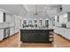 Open concept kitchen with dark island, stainless appliances, and adjacent dining area at 3610 Legareville Rd, Johns Island, SC 29455