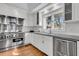 Well-appointed kitchen boasts stainless steel appliances, granite countertops, white cabinetry, and a view at 3610 Legareville Rd, Johns Island, SC 29455