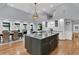 Open concept kitchen features an island, ample counter space, hardwood floors, and stainless appliances at 3610 Legareville Rd, Johns Island, SC 29455