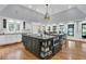 Gourmet kitchen with central island, granite countertops, and bar seating at 3610 Legareville Rd, Johns Island, SC 29455