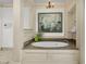 Main bathroom features a jacuzzi tub with decorative tile and a large window at 3610 Legareville Rd, Johns Island, SC 29455