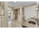 Beautiful main bathroom boasts a glass enclosed shower and a marble countertop sink at 3610 Legareville Rd, Johns Island, SC 29455