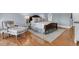 Comfortable main bedroom featuring a decorative rug and a cozy sitting area at 3610 Legareville Rd, Johns Island, SC 29455