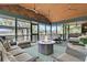 Relaxing screened porch with a fire pit, comfortable seating, and views of the surrounding landscape at 3610 Legareville Rd, Johns Island, SC 29455