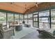 Relaxing screened porch with comfortable seating, ceiling fans, and a cozy fire pit overlooking the water at 3610 Legareville Rd, Johns Island, SC 29455