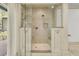 Luxurious glass shower has neutral tile, a built-in bench, and multiple shower heads at 3610 Legareville Rd, Johns Island, SC 29455