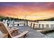 Dockside at sunset showcasing wood chairs, calm water, and beautiful views at 3610 Legareville Rd, Johns Island, SC 29455