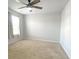 Carpeted bedroom featuring ceiling fan and window with white curtain at 362 Lake Ridge Blvd, Summerville, SC 29486