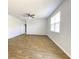Bright, empty bedroom with hardwood floors, white walls, and natural light from window at 362 Lake Ridge Blvd, Summerville, SC 29486