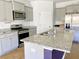 Stylish kitchen showcasing gray cabinets, granite countertops, stainless steel appliances, and a spacious island at 362 Lake Ridge Blvd, Summerville, SC 29486