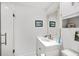 Bathroom features white vanity with storage, large mirror, and shower with glass door at 364 Dupre Rd, McClellanville, SC 29458