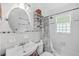 All-white bathroom featuring a vanity, matching toilet, and shower/tub combo with shower curtain at 364 Dupre Rd, McClellanville, SC 29458
