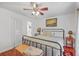 Bright bedroom features hardwood floors, ceiling fan, and an en suite bathroom through the door at 364 Dupre Rd, McClellanville, SC 29458