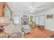 Cozy living room with wood floors, fireplace, and lots of light from the large windows at 364 Dupre Rd, McClellanville, SC 29458
