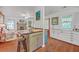 Open living space flows from kitchen, with an island, to living room with fireplace at 364 Dupre Rd, McClellanville, SC 29458