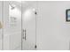 Walk-in shower features white tile surround, glass door, and shower caddy built into the wall at 364 Dupre Rd, McClellanville, SC 29458