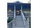 Home's entrance with an elevated porch, stairs and classic architectural details at 364 Dupre Rd, McClellanville, SC 29458