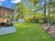 Lush backyard featuring a storage shed and a partial view of the screen porch at 411 Red Fox Run, Summerville, SC 29485