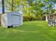 Spacious backyard featuring a storage shed, well-manicured lawn, and partial view of the house at 411 Red Fox Run, Summerville, SC 29485