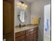 Traditional bathroom features a wood vanity with granite countertop and oval mirror at 411 Red Fox Run, Summerville, SC 29485