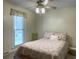 Cozy bedroom with a ceiling fan, large window, and patterned comforter at 411 Red Fox Run, Summerville, SC 29485