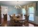 Charming dining room with hardwood floors, chandelier, and ample natural light at 411 Red Fox Run, Summerville, SC 29485
