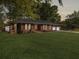 Traditional brick ranch home with a well-kept lawn and double garage, radiating timeless charm at 411 Red Fox Run, Summerville, SC 29485