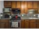 Efficient kitchen layout with stainless steel appliances, wood cabinets, and solid countertops at 411 Red Fox Run, Summerville, SC 29485