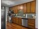 Functional kitchen featuring stainless steel appliances, solid countertops, and wood cabinets at 411 Red Fox Run, Summerville, SC 29485