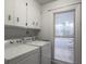 Well-lit laundry room featuring a washing machine and dryer next to a bright window at 411 Red Fox Run, Summerville, SC 29485
