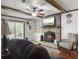 Cozy living room featuring a brick fireplace with mounted TV and sliding door at 411 Red Fox Run, Summerville, SC 29485