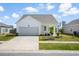 Attractive single-story home with a garage, well-manicured landscaping, and a paved driveway at 412 Pender Woods Dr, Summerville, SC 29486