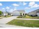 Inviting single-story home featuring a driveway, well-maintained lawn, and a welcoming facade at 412 Pender Woods Dr, Summerville, SC 29486