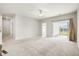 Bright living room with sliding glass doors to patio, features plush carpeting and modern ceiling fan at 412 Pender Woods Dr, Summerville, SC 29486