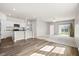 Open-concept living space combines kitchen, dining, and living areas with hardwood floors and plush carpeting at 412 Pender Woods Dr, Summerville, SC 29486