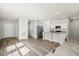 Open-concept living space featuring hardwood floors, adjacent to a kitchen and carpeted living room at 412 Pender Woods Dr, Summerville, SC 29486