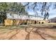 View of backyard with wood fence, lawn, mature trees and building at 415 Parkdale Dr # 12D, Charleston, SC 29414