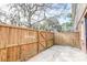 Fenced backyard with concrete patio and mature trees at 415 Parkdale Dr # 12D, Charleston, SC 29414
